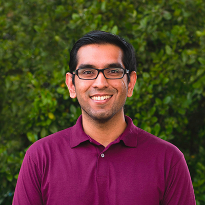 Ashish Hingle, IST PhD student at George Mason, wears a magenta shirt and glasses in his profile.