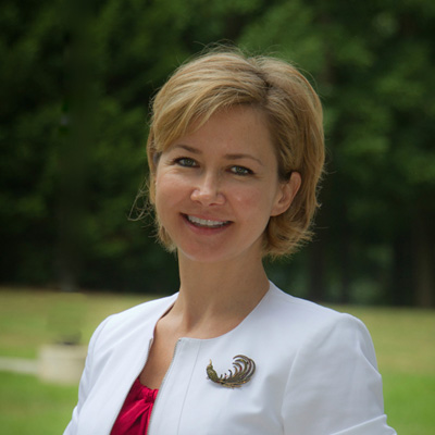 Ioulia Rytikova wears a white blazer and red blouse in her faculty profile for the IST department at George Mason University.