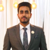 Ahnaf Atef Choudhury, IST PhD student at Mason, wears a gray, plaid suit and blue tie in his profile.