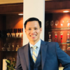 Khanh Nguyen, IST PhD at Mason, wears a blue suit, yellow tie, and glasses in his profile.